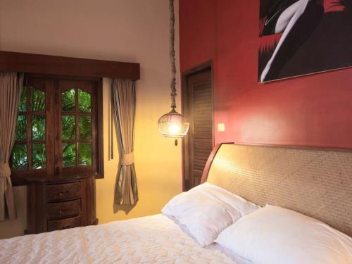 a bedroom with a white bed and a red wall at 7 Bedroom Seafront Villa Phangan SDV232-By Samui Dream Villas in Srithanu