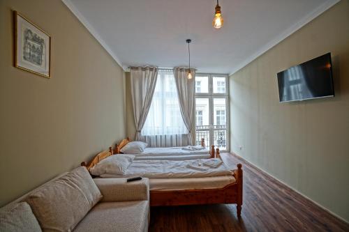 Posteľ alebo postele v izbe v ubytovaní Apartamenty Grodzka 8