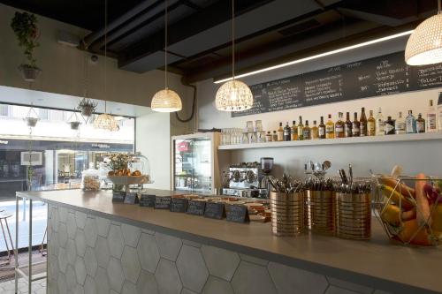 a bar in a restaurant with a counter and lights at Townhouse Boutique Hotel in Zürich