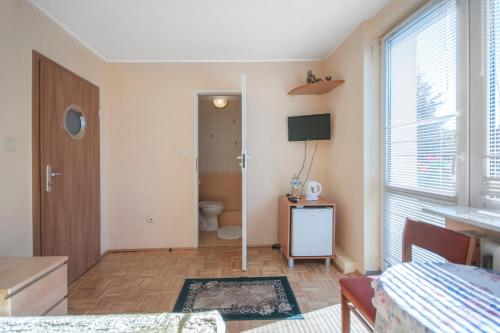 a living room with a toilet and a window at Roza Wiatrow in Chłopy