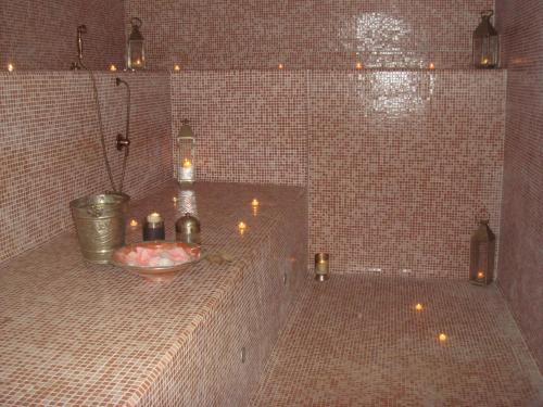 a bathroom with candles and a tub with a sink at Amareclub Baia Dei Turchi Resort - Adults Only in Otranto
