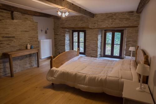 a large bedroom with a large bed in a room at Gîte Coeur de Beurre in Louette-Saint-Denis