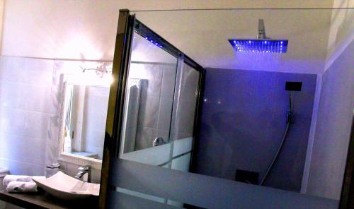 a bathroom with a sink and a shower with a mirror at Barberini Dream in Rome