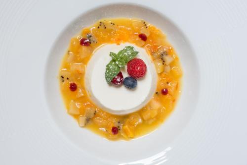 a plate with a dessert with fruit on it at Hotel Athena in Siena