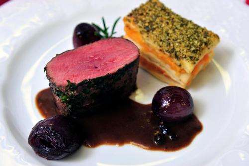 a plate of food with a piece of cake and berries at Badener Hof in Baden