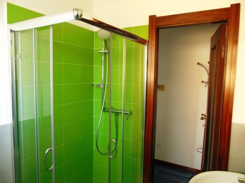 a green tiled shower in a bathroom with a toilet at Deiva Holidays in Deiva Marina