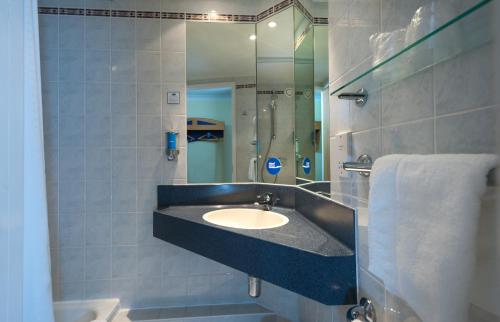 a bathroom with a sink and a mirror at Holiday Inn Express Walsall M6, J10, an IHG Hotel in Walsall