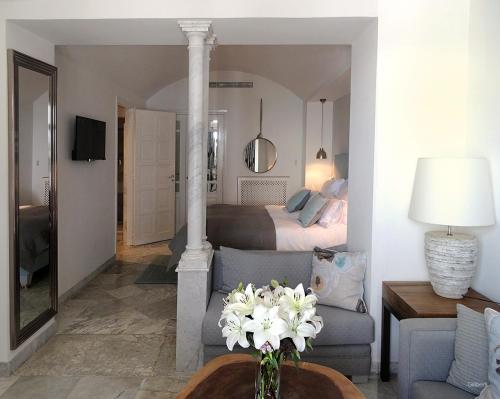 a living room with a bed and a vase of flowers at La Villa Bleue-Sidi Bou Said in Sidi Bou Saïd