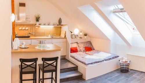 a small room with a bed in the attic at Podkroví na Králově Výšině in Ústí nad Labem