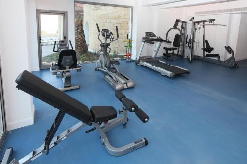 a gym with several exercise equipment on a blue floor at Droushia Heights Hotel in Droushia