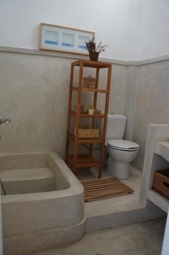 a bathroom with a bath tub and a toilet at Almyra Kythera in Agia Pelagia Kythira