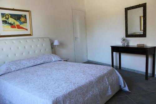 PartannaにあるVilletta Valle del Belìceのベッドルーム(ベッド1台、テーブル、鏡付)
