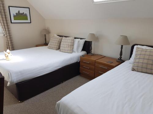 A bed or beds in a room at Loch Ness Guest House 