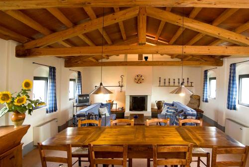 a dining room with a wooden table and chairs at Agriturismo Pian Del Tevere in Torgiano