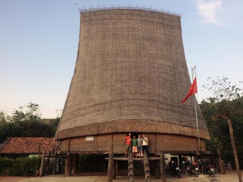 a group of people standing on a building with a water tower at Vietnam Phuot Real Home in Kon Tum