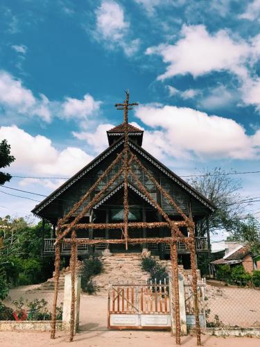 a church with a cross on the top of it at Vietnam Phuot Real Home in Kon Tum