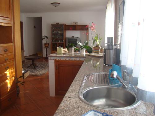 a kitchen with a sink and a counter top at Casa das Merces in Angra do Heroísmo