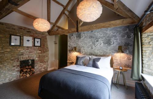 a bedroom with a bed and a fireplace at The Litton in Litton