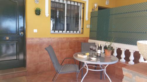 a table and chairs in a room with a window at Apartamentos casa Tia Antonia in Málaga