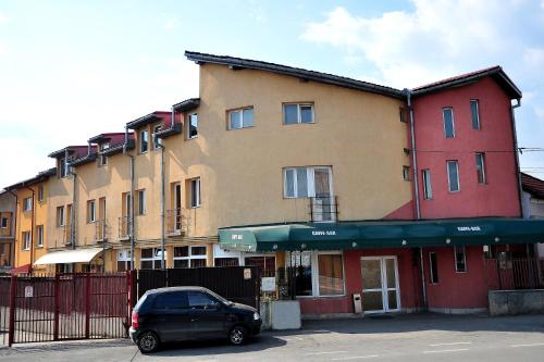 a black car parked in front of a building at Casa Otilia in Cluj-Napoca