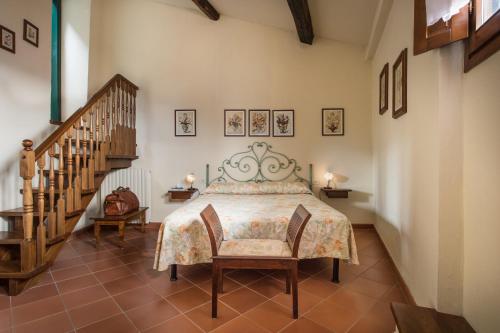 a bedroom with a bed and a staircase at Casa Vacanze Villa il Castellaccio in Lucolena in Chianti