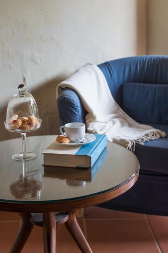 a coffee table with a cup of coffee and a book at Casa Vacanze Villa il Castellaccio in Lucolena in Chianti