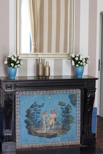 a painting on a table in a room with a mirror at Domaine des Lilas in Saint-Germain-Lembron