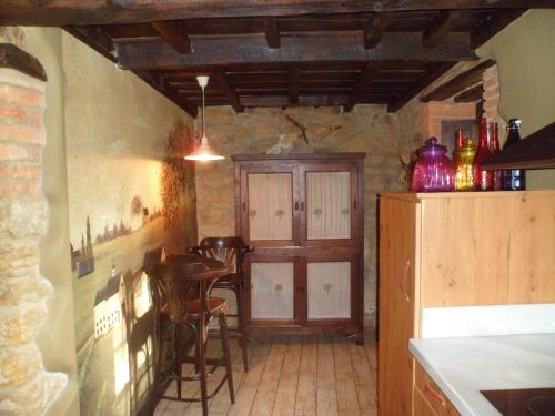 a kitchen with a table and chairs and a refrigerator at Casa Rural La Retuerta in Nava