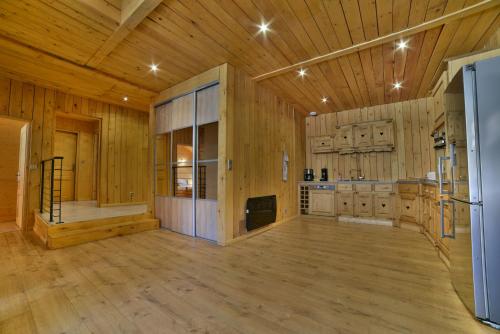a large room with wooden walls and a wooden floor at Appartement Le Chalet in Ornans