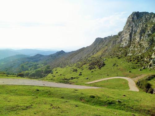 a winding road on a hill with a mountain at Casa Rural La Retuerta in Nava