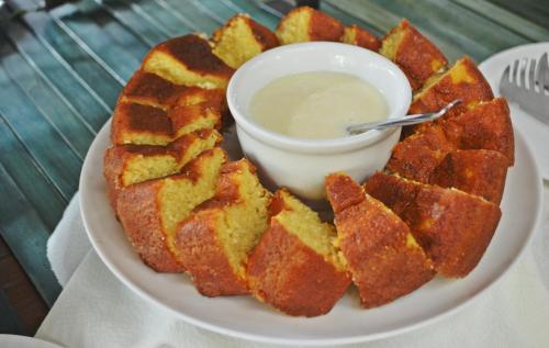 a plate of food with bread and dipping sauce at Villa'l Mare Hotel in Maresias