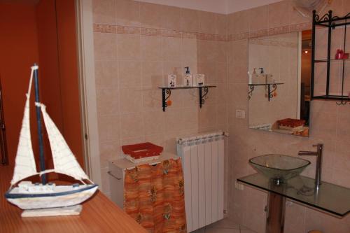 a bathroom with a counter and a sink in it at La Sorgente Apartment with private pool in Calice Ligure