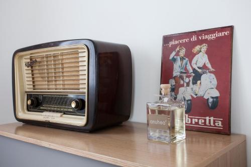 a toaster oven sitting on a shelf next to a book at Le Dimore del Borgo in Lucca