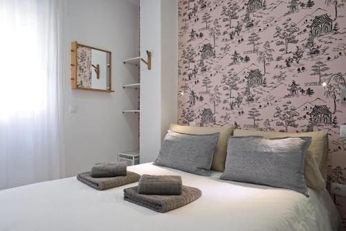 a bedroom with a bed and a painting on the wall at Luxury Apartment Picasso in Málaga