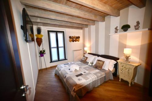 a bedroom with a bed and a table and a window at Appartamenti Volta in Como