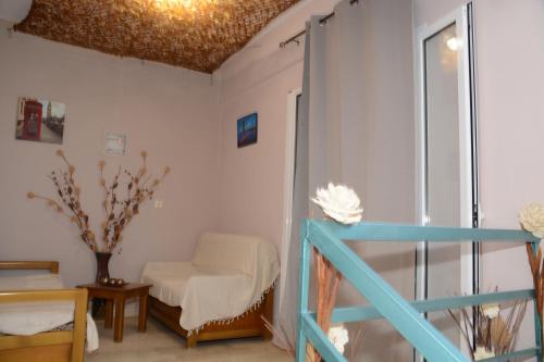 a room with white walls and a ceiling with a window at Pension Elena in Ágios Nikólaos