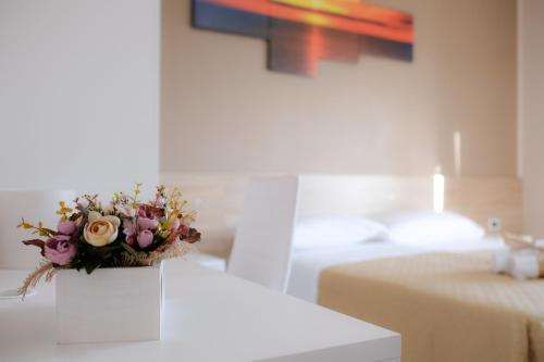 a bouquet of flowers sitting on top of a table at B&B Lamezia Airport in Lamezia Terme