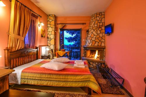 a bedroom with a bed and a fireplace at Voreio Selas in Synikia Mesi Trikalon