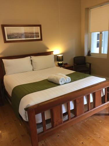 a bedroom with a large bed with a green blanket at Little River Bed and Breakfast in Little River