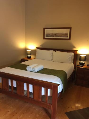 a bedroom with a bed with two towels on it at Little River Bed and Breakfast in Little River