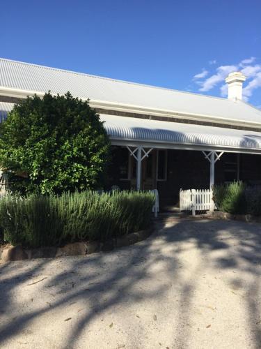 a building with a fence in front of it at Little River Bed and Breakfast in Little River