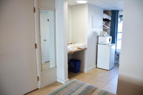 a small kitchen with a white refrigerator and a counter at Crest Motel in Old Orchard Beach