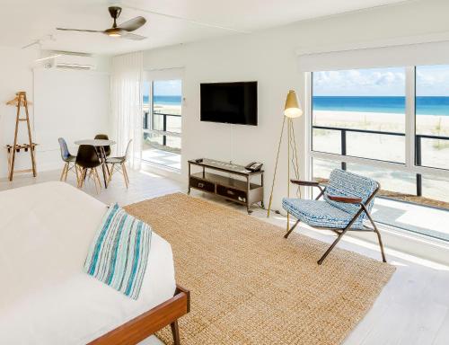 a living room with a bed and a view of the ocean at Plunge Beach Resort in Fort Lauderdale