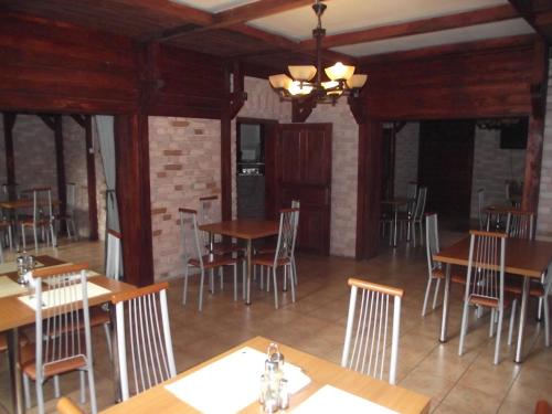 a dining room with wooden tables and chairs at Villa Carmelita in Craiova