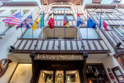 a bunch of flags on the front of a building at Hotel Relais Saint Jean Troyes in Troyes