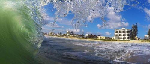 a large wave in the ocean near a beach at Albatross North Apartments in Gold Coast