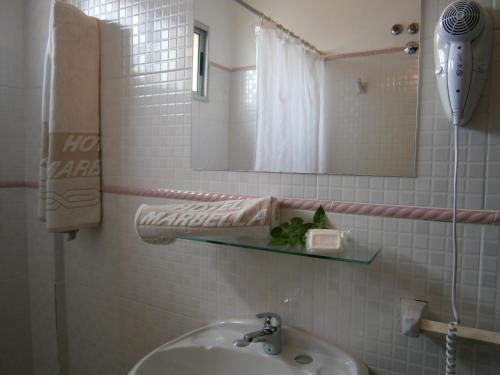 a bathroom with a sink and a mirror at Hotel Marbella in Punta del Este