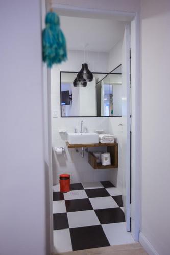 a bathroom with a black and white checkered floor at Bosque Divino Cabañas & Suites in Valle Grande