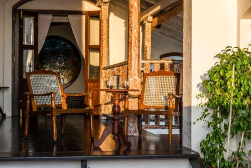 a dining room with two chairs and a table at Prince of Galle (inside the Fort) in Galle