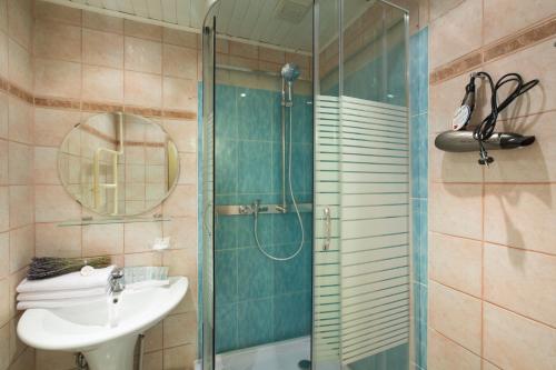 a bathroom with a glass shower and a sink at Lux Apartments Bolshoy Afanasievsky pereulok in Moscow